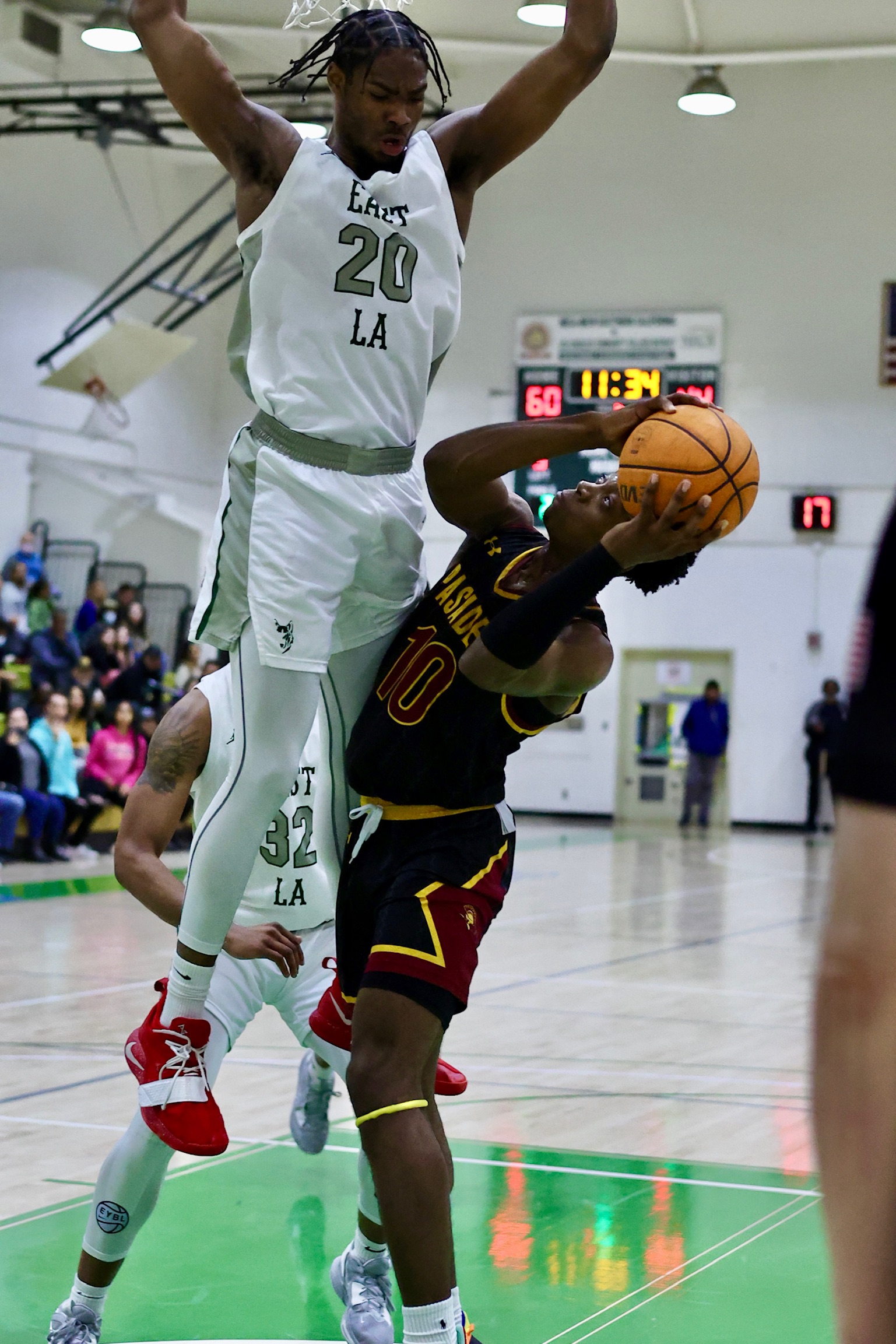East LA's JT Langston towers over Pasadena's Jonthan Tchengang in a recent SCC game (photo by Michael Watkins).
